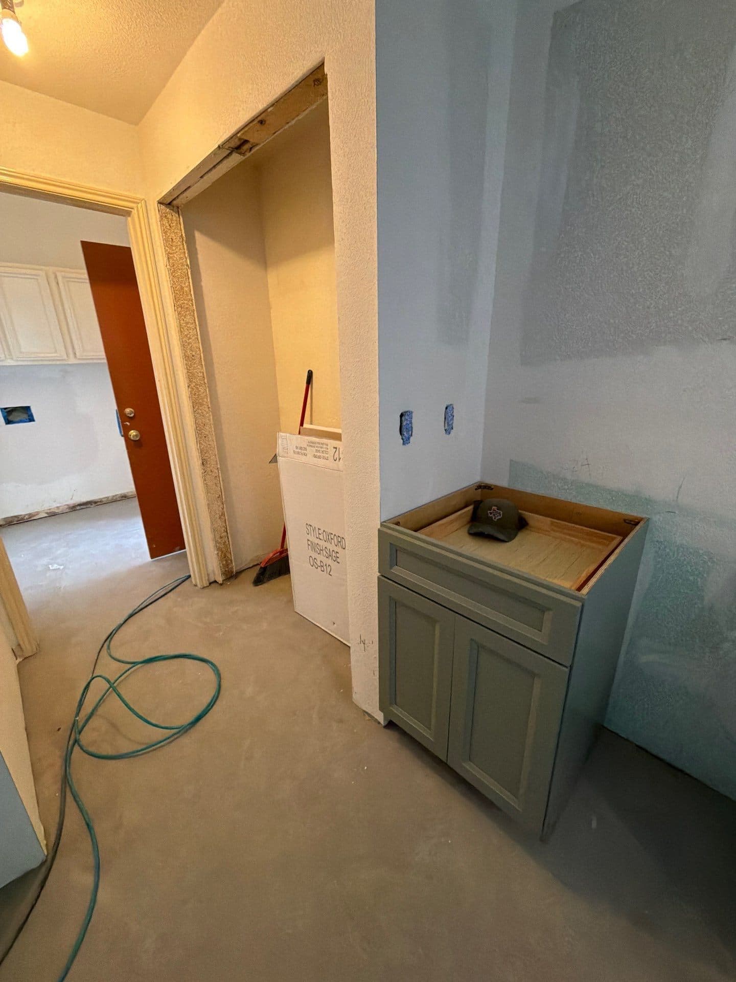 New sage vanity set in place in the bath, walls floated and awaiting counter and flooring