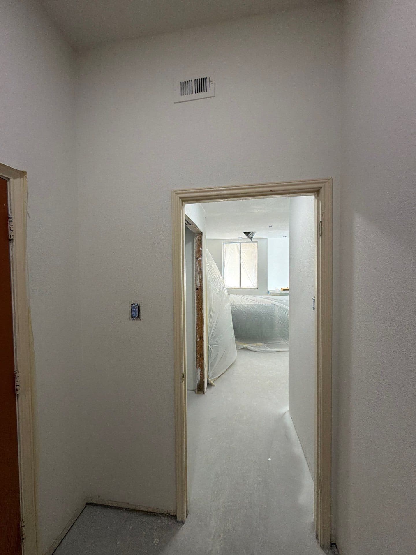 Doorway vista through freshly painted rooms with recessed lighting
