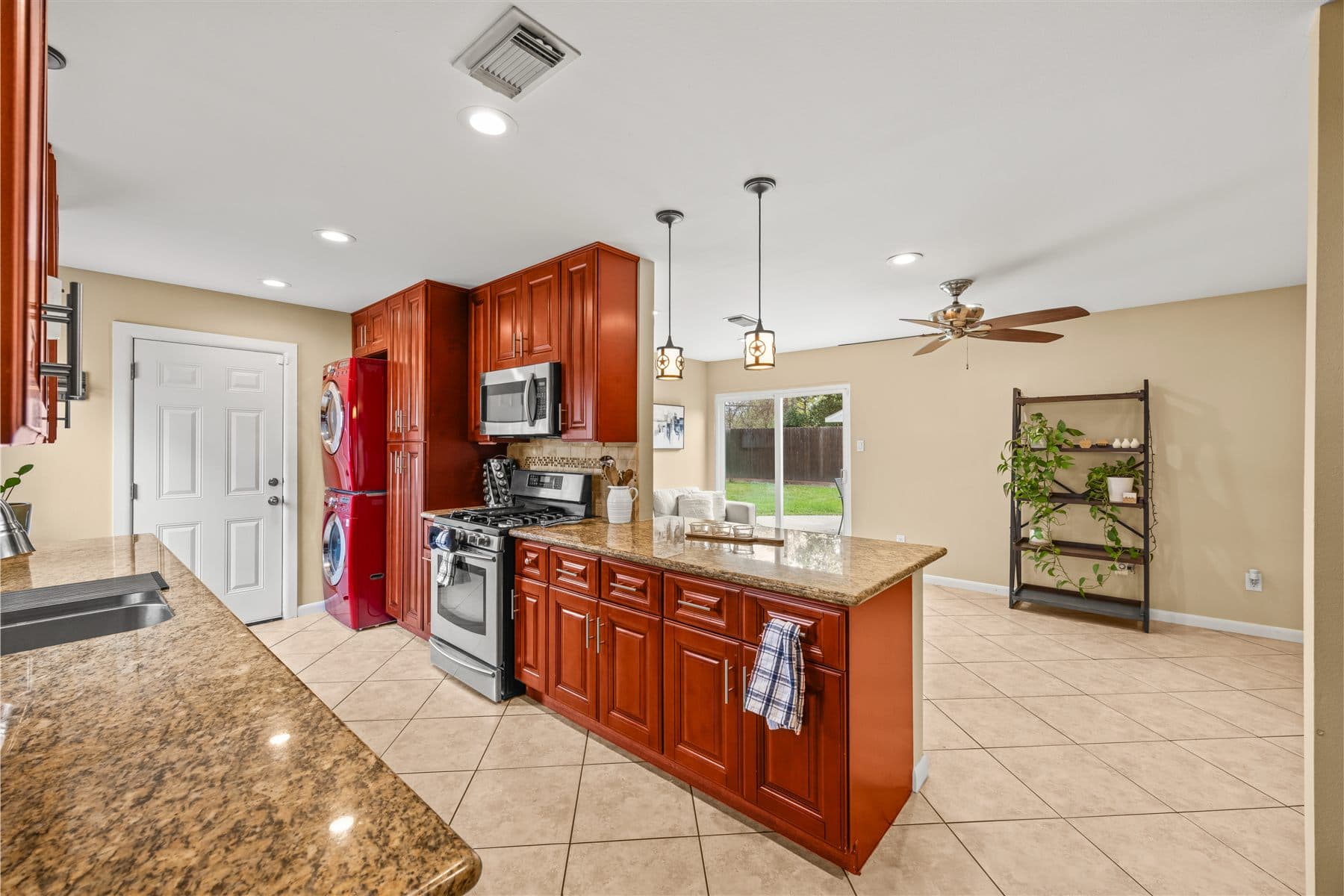Kitchen with cherry cabinets, granite counters, and stainless appliances, finished by the Reborn group