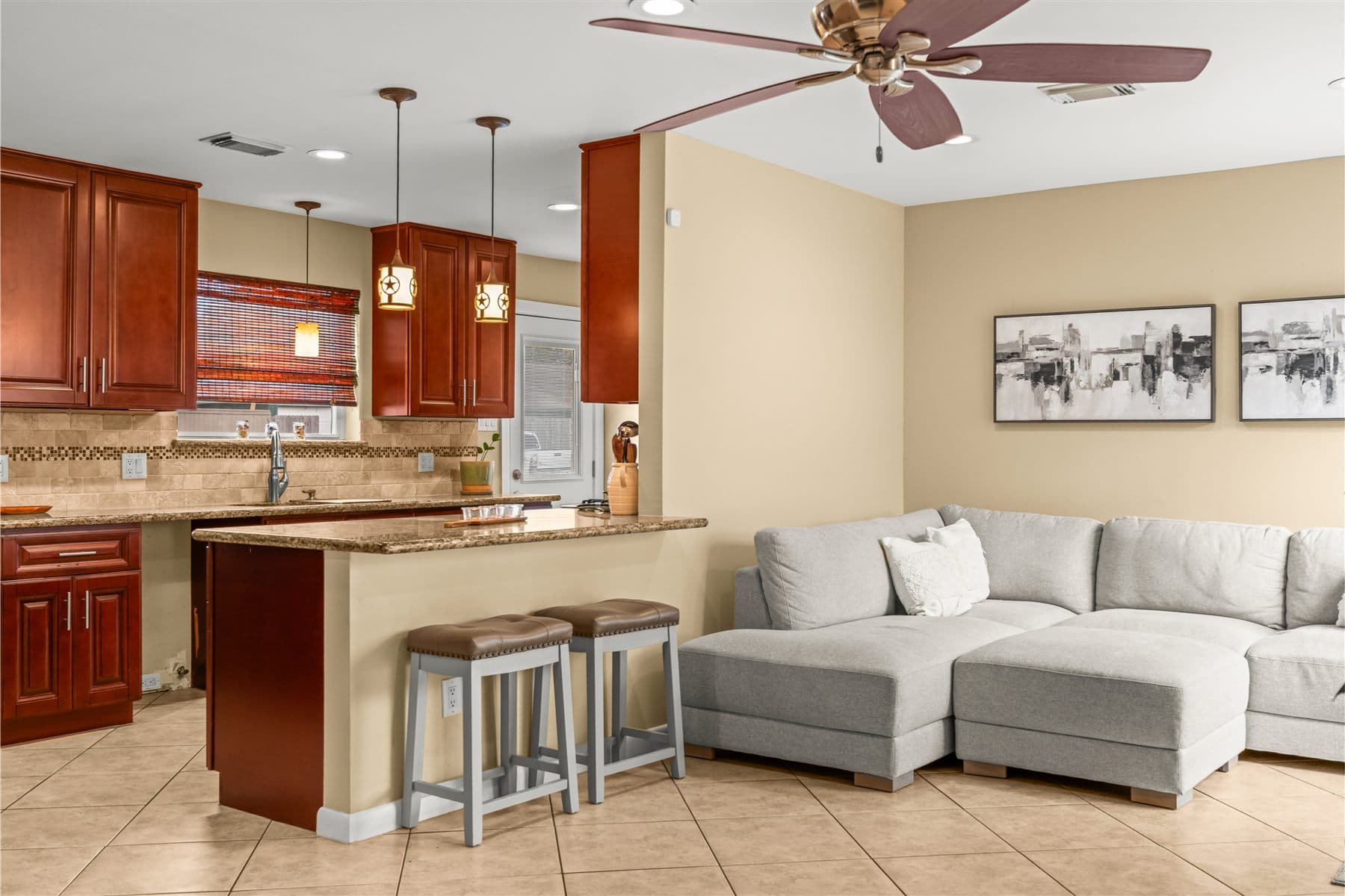Open living area seen from the kitchen island, furnished by the Reborn group