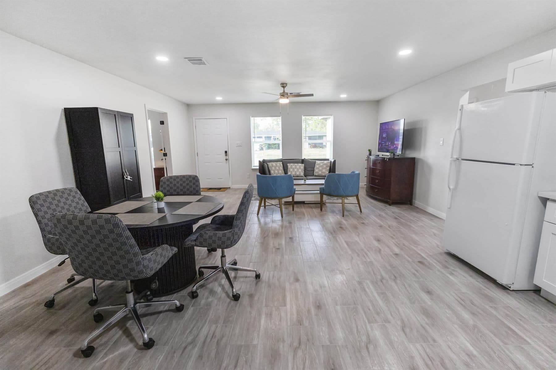 Open kitchen and dining area with round table, finished by the Reborn group